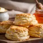 Easy 3 Ingredient Biscuit Recipe – Incredibly Fluffy & Delicious Every Time 9 Close-up of fluffy 3 ingredient biscuit recipe with honey and butter on a rustic tray