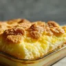 Freshly baked lemon cream cheese dump cake in a baking dish